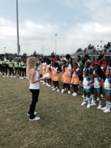 A Science Cheerleader leads Pop Warner cheerleaders on study of microbes on Earth and on the Space Station.